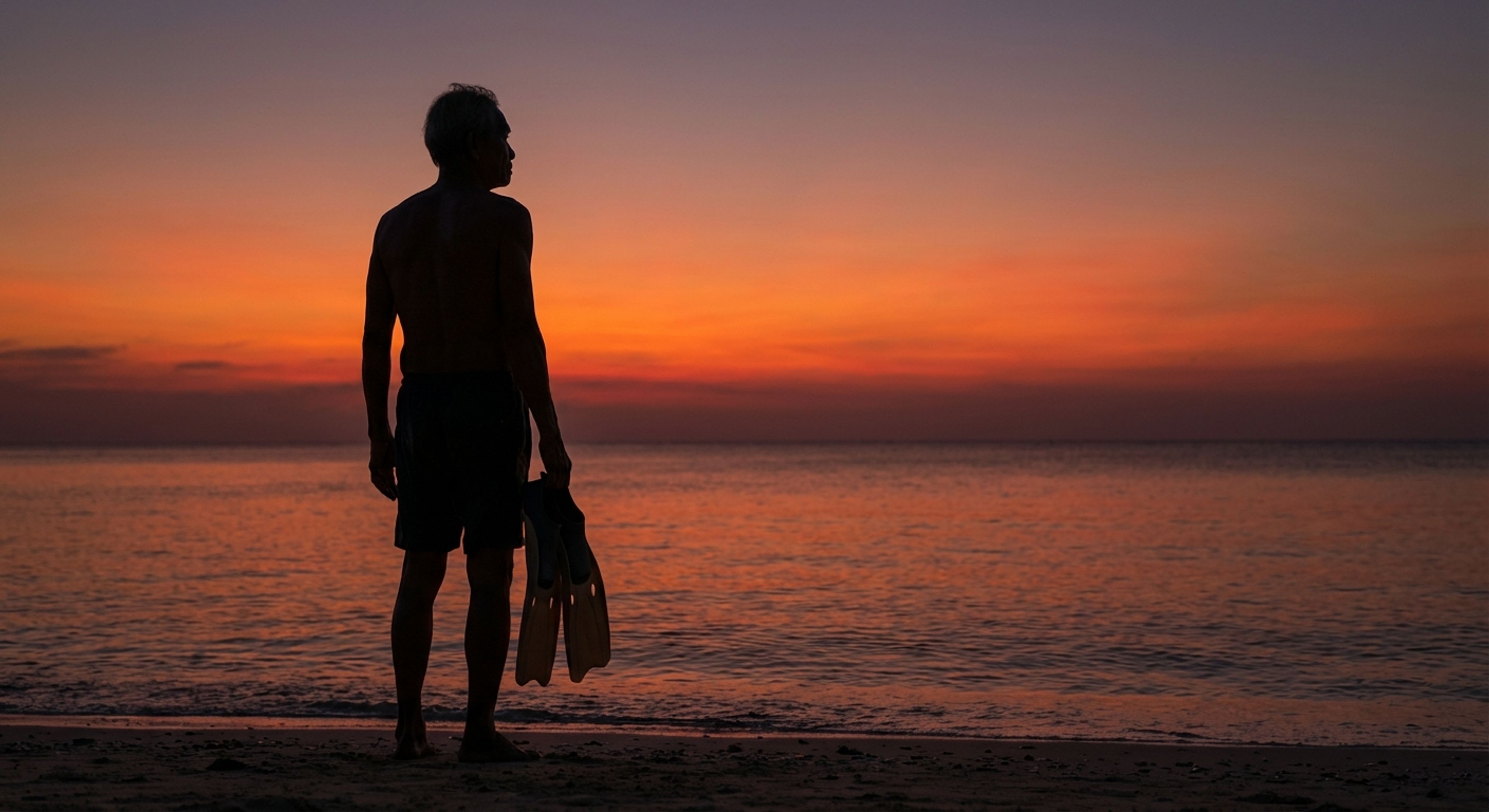 Old diver looking at sunset