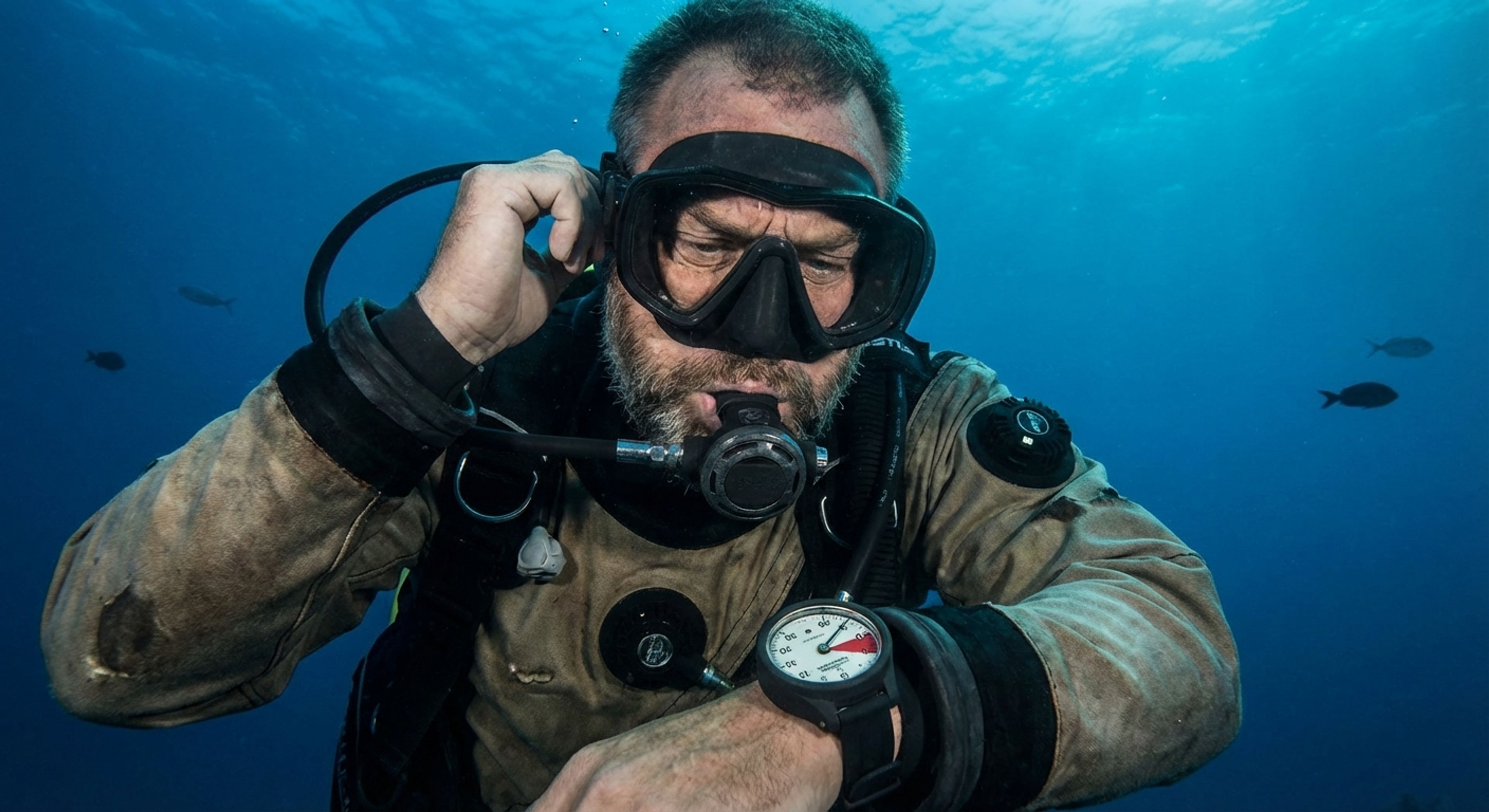 A frustrated dive master looking at a pressure gauge
