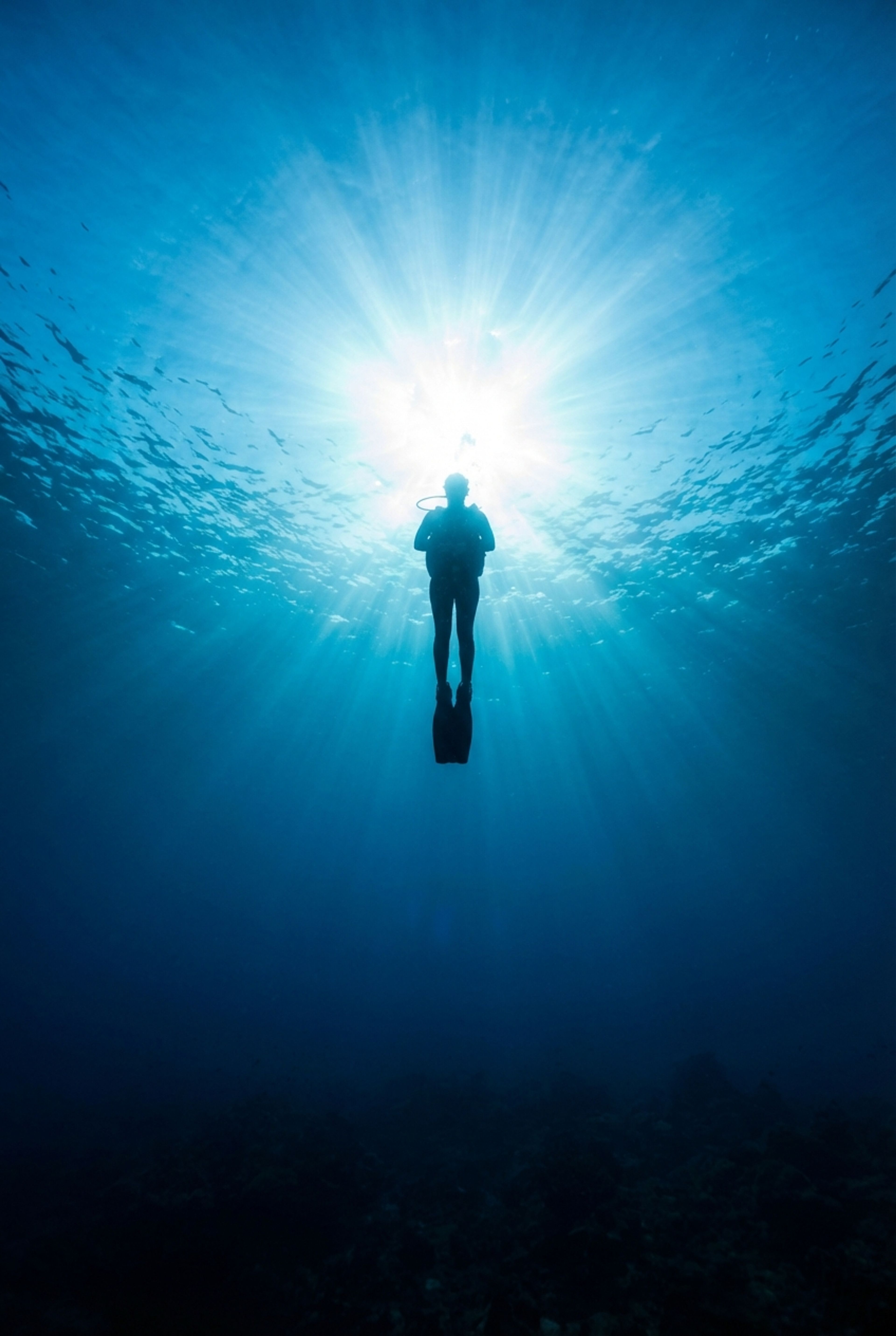 Diver silhouette with sunburst